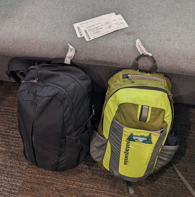 Two backpacks and plane tickets