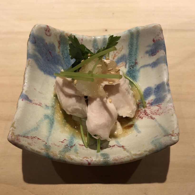 Small dish of poached chicken breast.